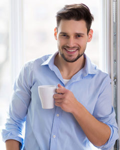 man happy holding coffee mug