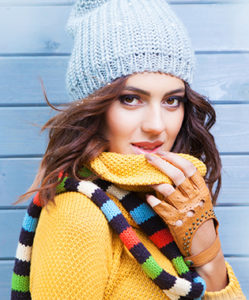 woman holding sweater near her mouth